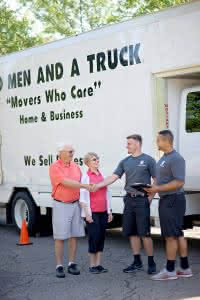 two men and a truck with a customer