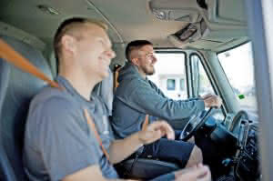 two men and a truck driving
