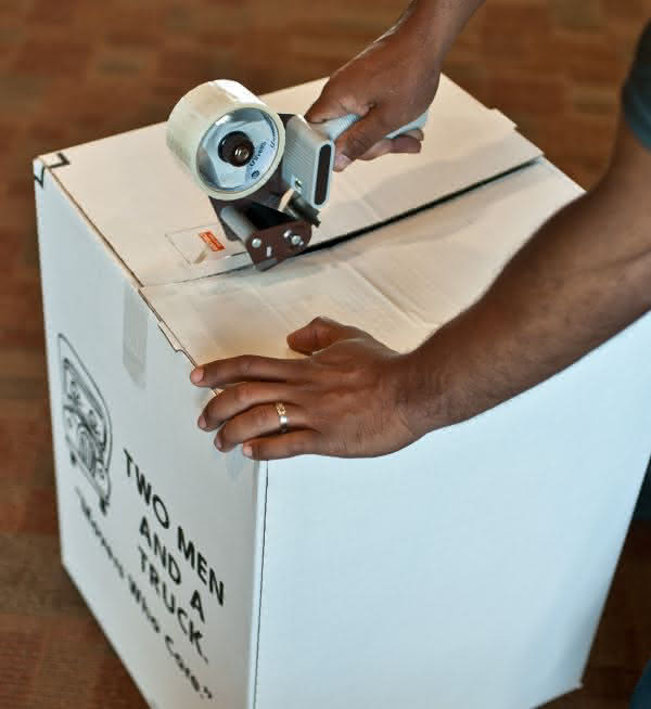 sealing moving box with tape gun